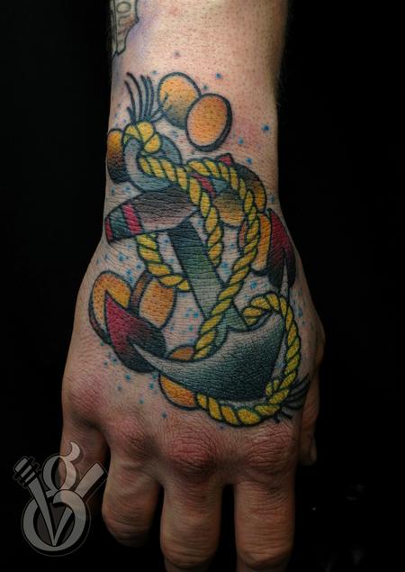 Jon von Glahn - traditional anchor hand tattoo gold pieces